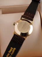  Case back of Vintage Omega ladies dress watch with silver dial, applied baton hour markers, 9ct solid gold case and brown leather strap, displayed in original Omega presentation box.