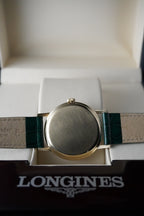 Longines watch with green strap on a white background