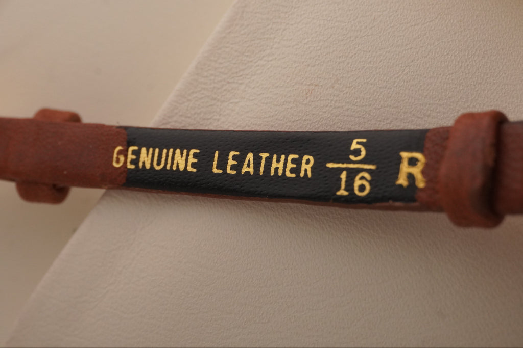 Brown leather belt with 'Genuine Leather' label on a white background