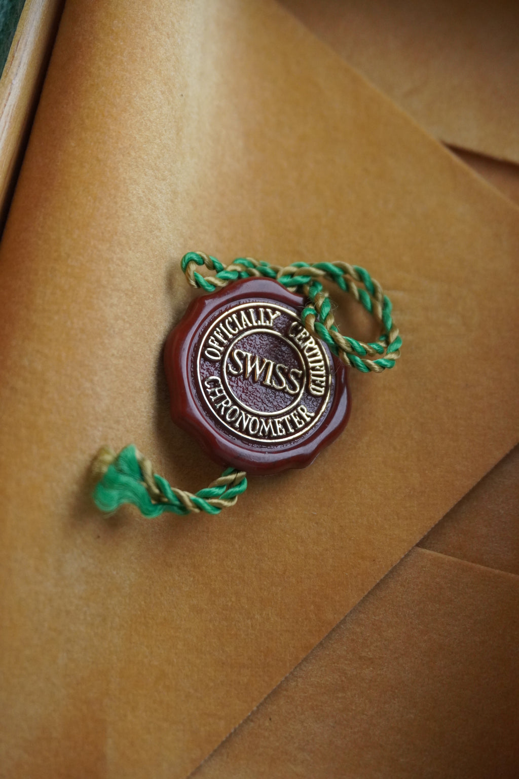 Rolex watchmaker's seal on a brown leather surface Chronometer