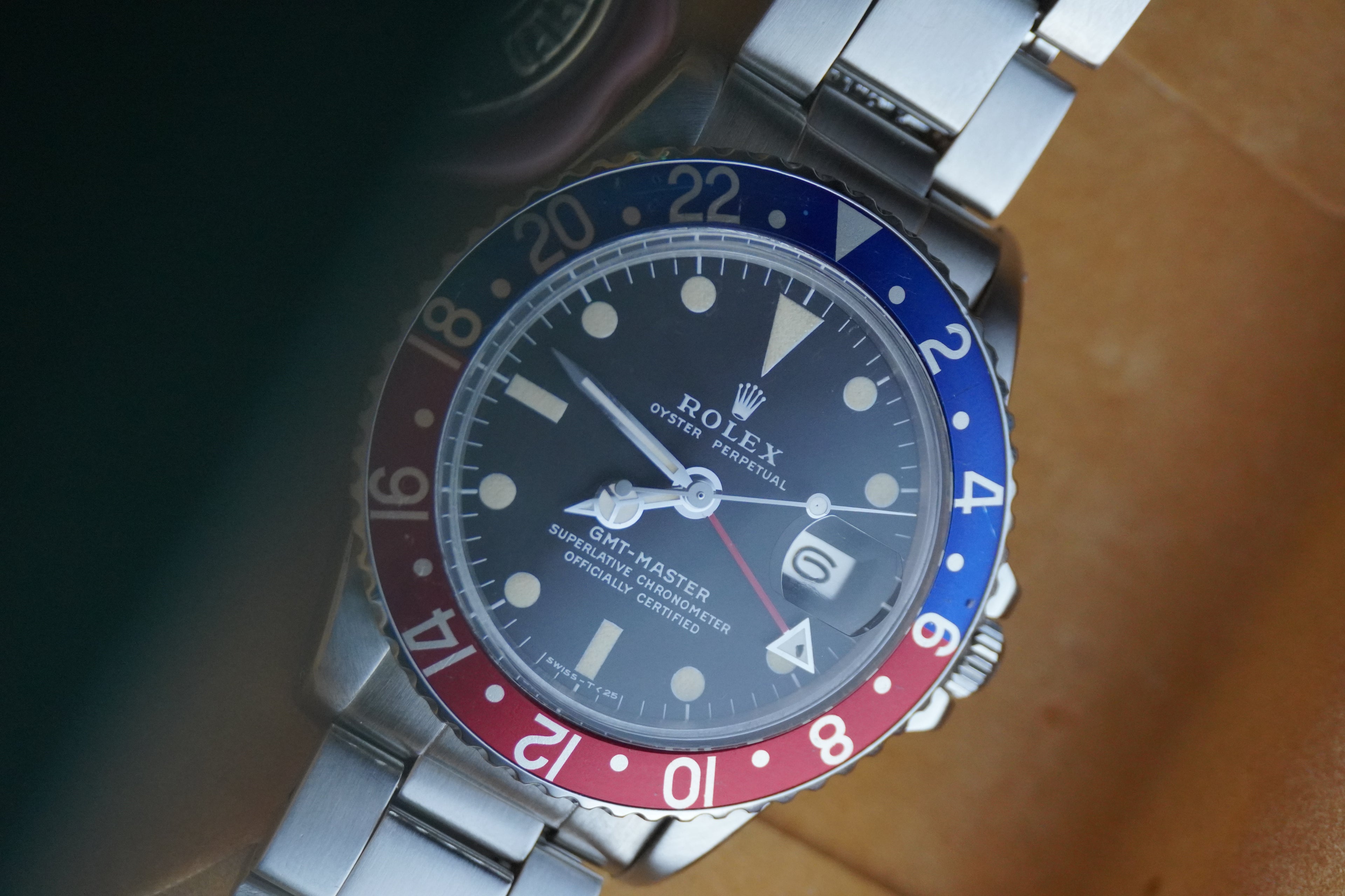 Vintage Rolex GMT-Master Pepsi bezel stainless steel watch with red and blue bezel insert, black dial, and Oyster bracelet displayed in original presentation box with Swiss chronometer seal.