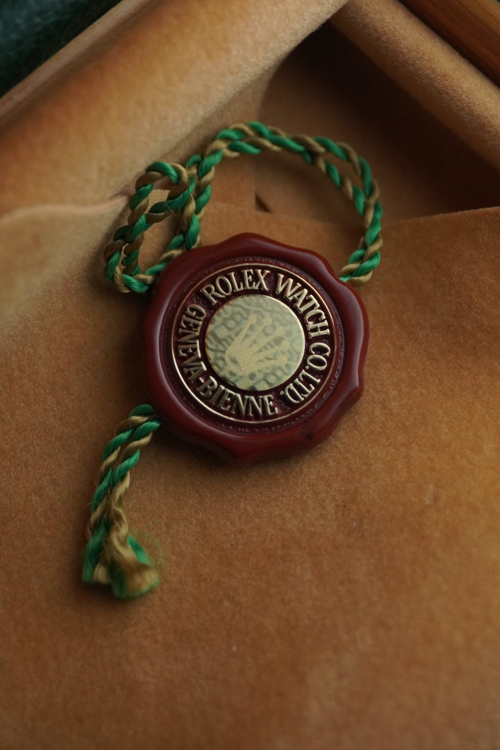 Rolex watchmaker's seal on a brown leather surface Chronometer