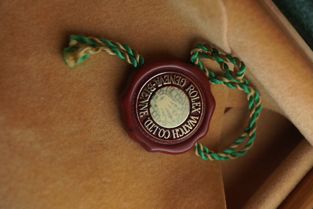 Rolex watchmaker's seal on a brown leather surface Chronometer