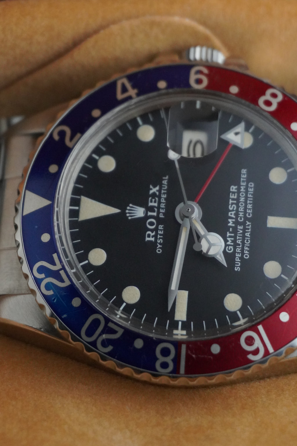 Close-up of a Rolex GMT-Master watch with a blue and red bezel.