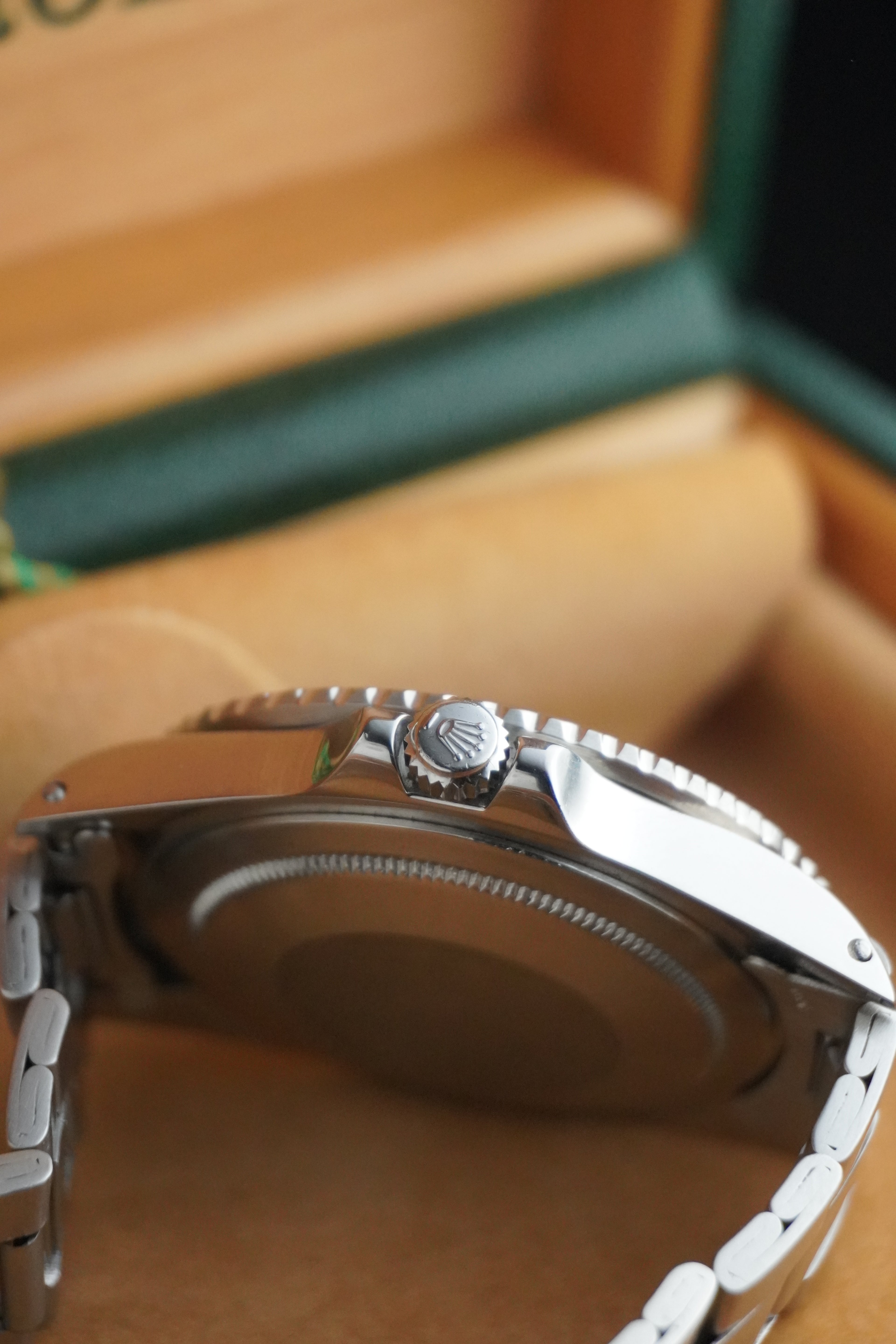 Vintage Rolex GMT-Master Pepsi bezel stainless steel watch with red and blue bezel insert, black dial, and Oyster bracelet displayed in original presentation box with Swiss chronometer seal.