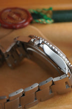 Vintage Rolex GMT-Master Pepsi bezel stainless steel watch with red and blue bezel insert, black dial, and Oyster bracelet displayed in original presentation box with Swiss chronometer seal. Ref 1675