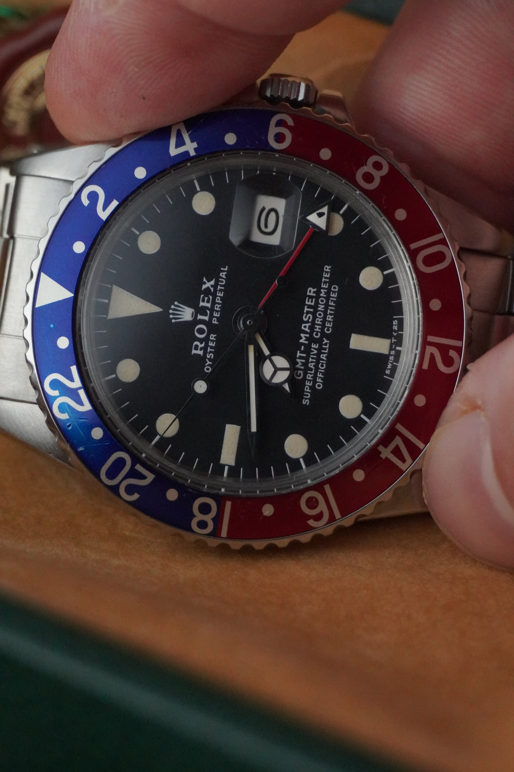 Vintage Rolex GMT-Master Pepsi bezel stainless steel watch with red and blue bezel insert, black dial, and Oyster bracelet displayed in original presentation box with Swiss chronometer seal. 1675
